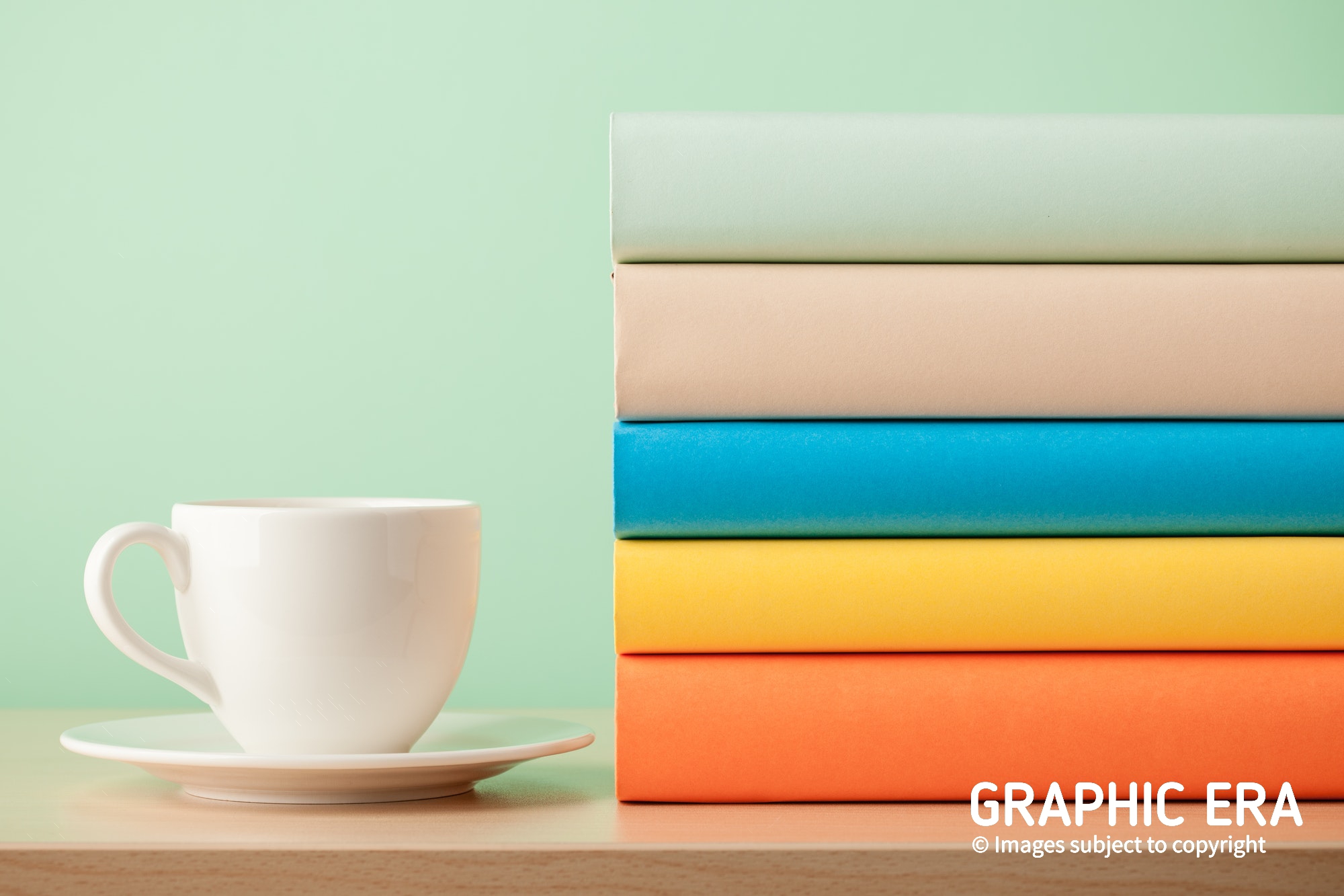 books and cup on wooden table